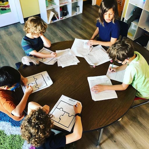 Group of second graders work together at table.