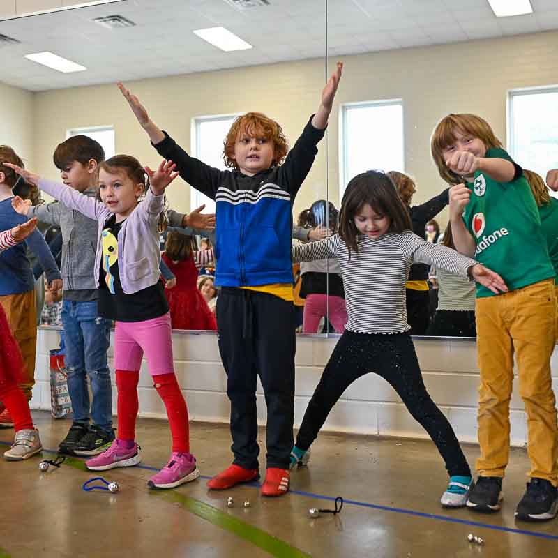 Kinder and first grade students perform in front of parents at showcase.