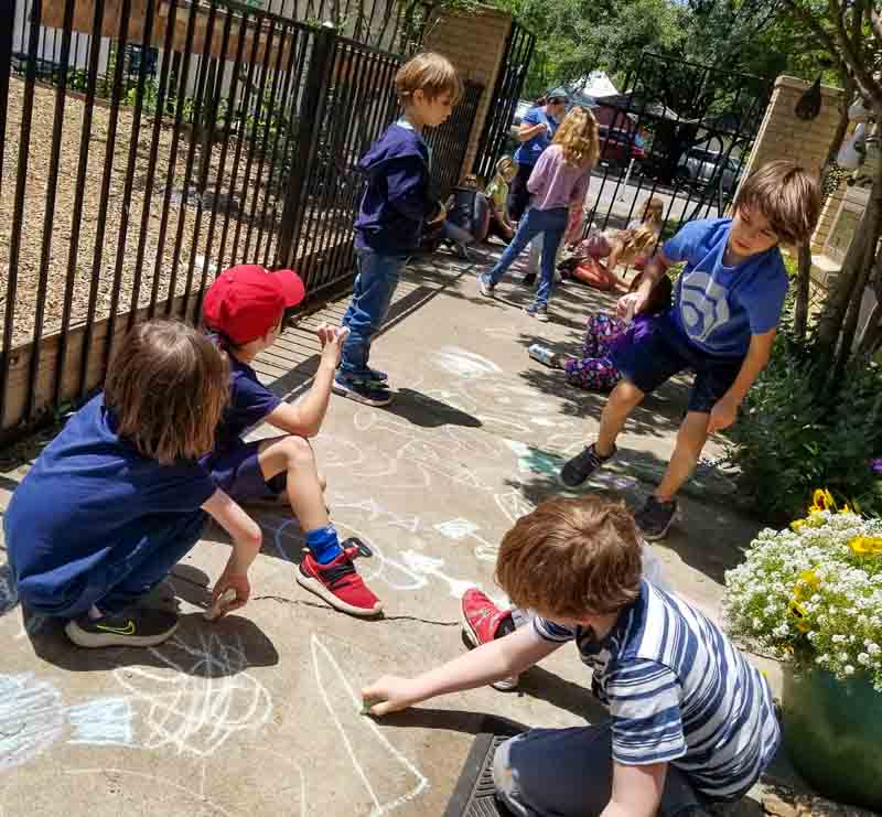 Students play with chalk and get outdoor time.