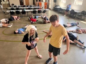 Middle schoolers spread out on floor at social emotional learning school.