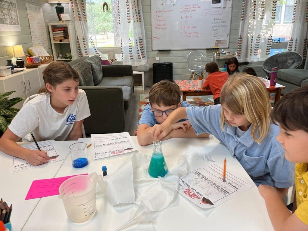 Students learn about chemistry by mixing chemicals in hands on progressive micro school.