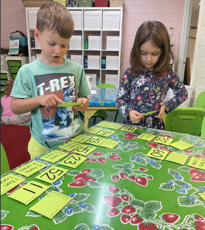 Kindergarten and first grade students use math manipulatives at hands on private school.