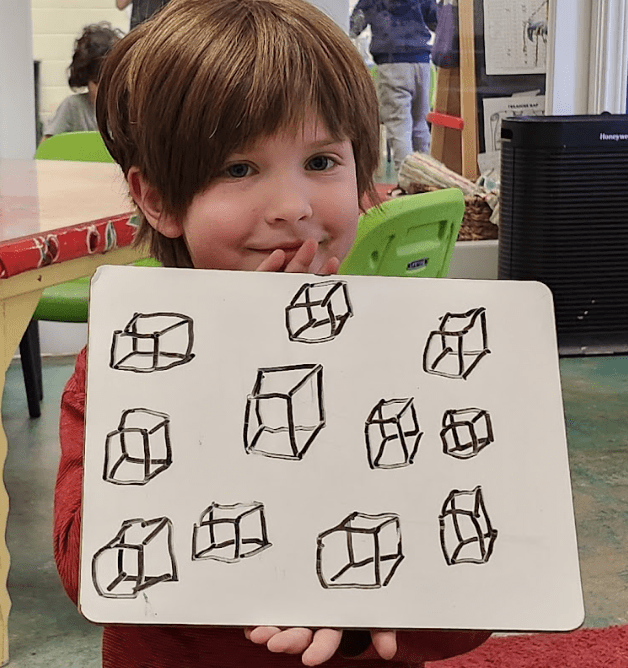 Kindergarten student at private elementary school displays math work.