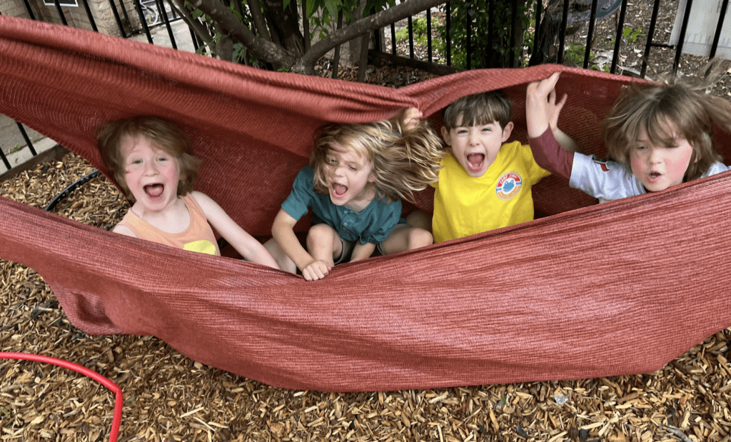Kindergarten kids having fun outdoors at part time school in Austin.