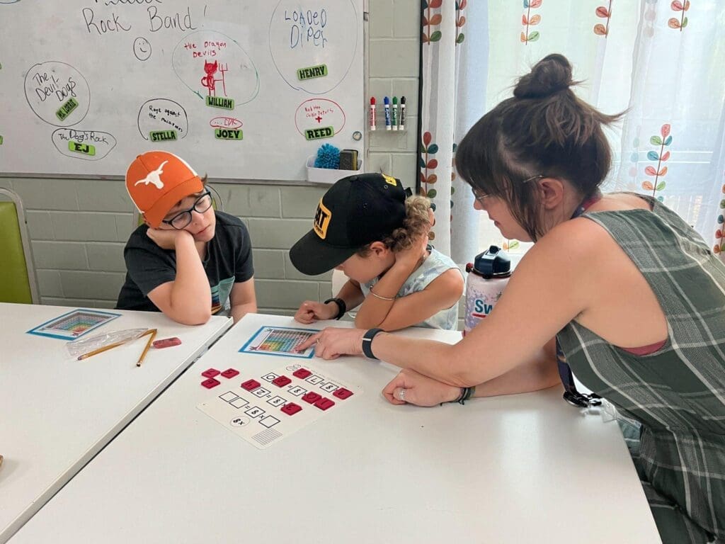 Teacher works with fifth grade boys at school with small class sizes.