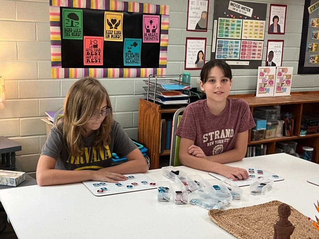 Two fifth grade students work on math at table at micro school in Austin.