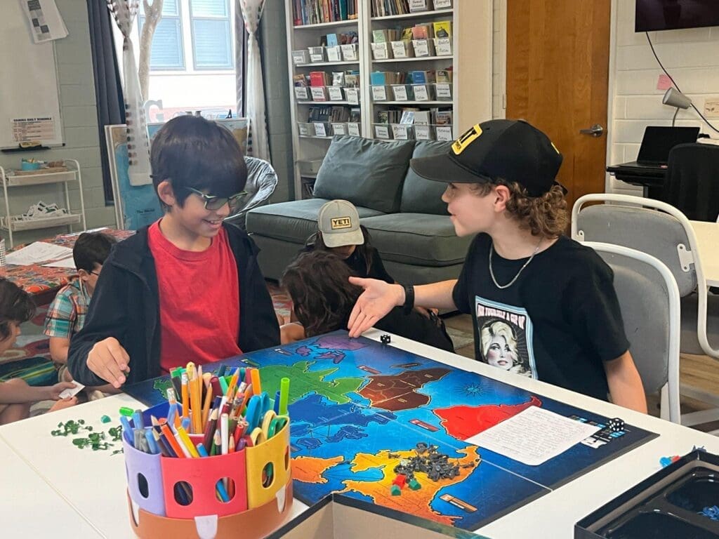 Two fourth grade students work on geography at private school in Austin.