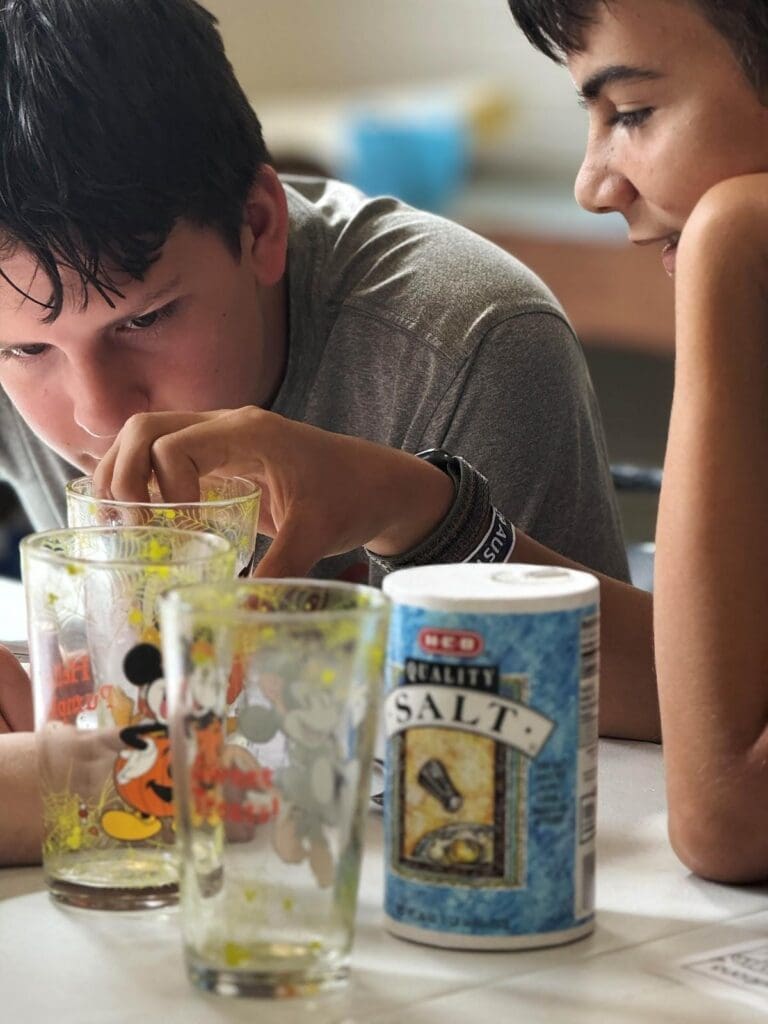 Two middle school students perform science experiment at STEM school.