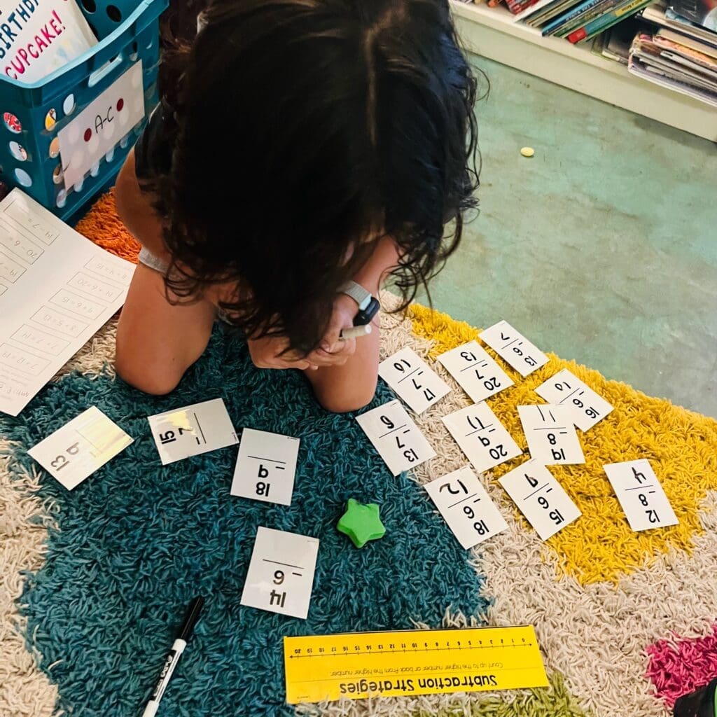 Second grade student focuses on math cards at private school in Austin.