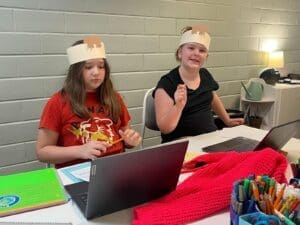 Fourth grade students wear head gear as they use computers at project based elementary school.