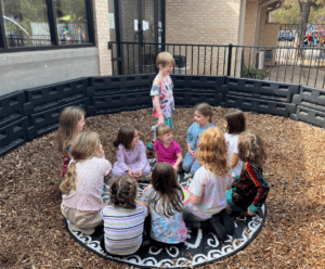 Kindergarten children play outdoor game at micro school.