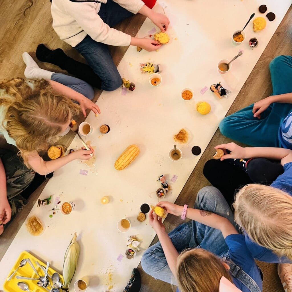 Second and third graders share Thanksgiving meal at project based school.