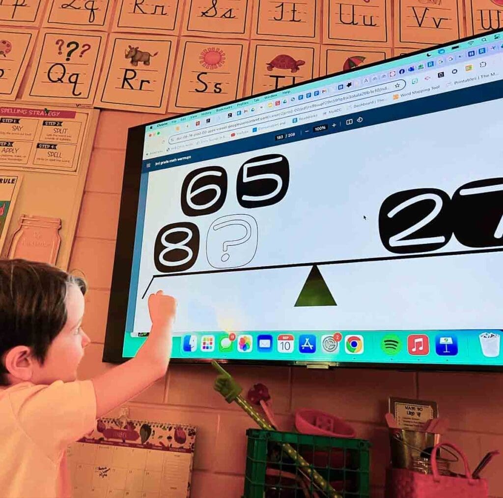 Academics Math Elementary student works with numbers on screen at GT school.