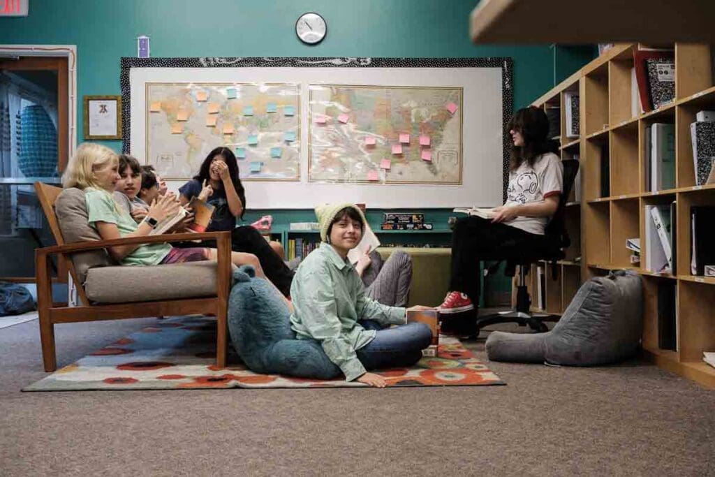 Austin Home Base Community School Middle schoolers sit around at inclusive school.