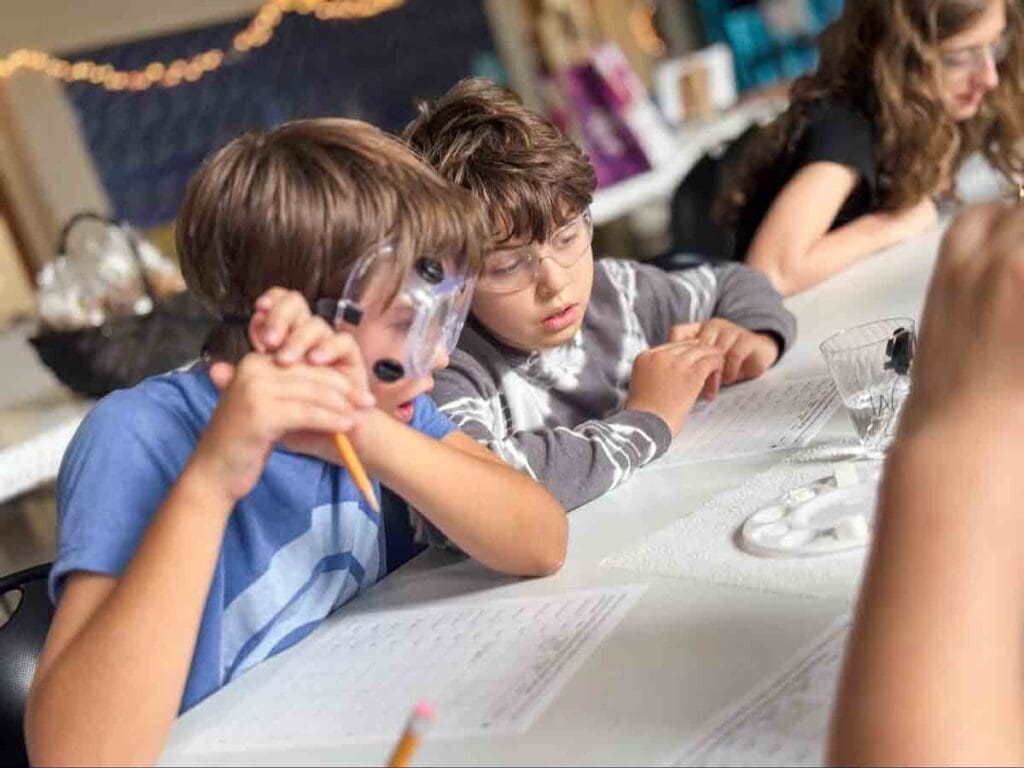 after school - Fridays Two private middle school students marvel at science project.
