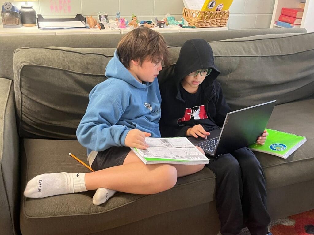 Two boys work together at school with SEL.