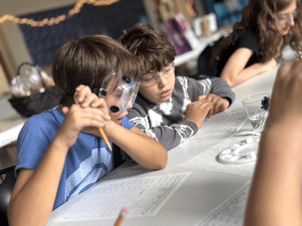 Two middle school students surprised about science at STEM school.