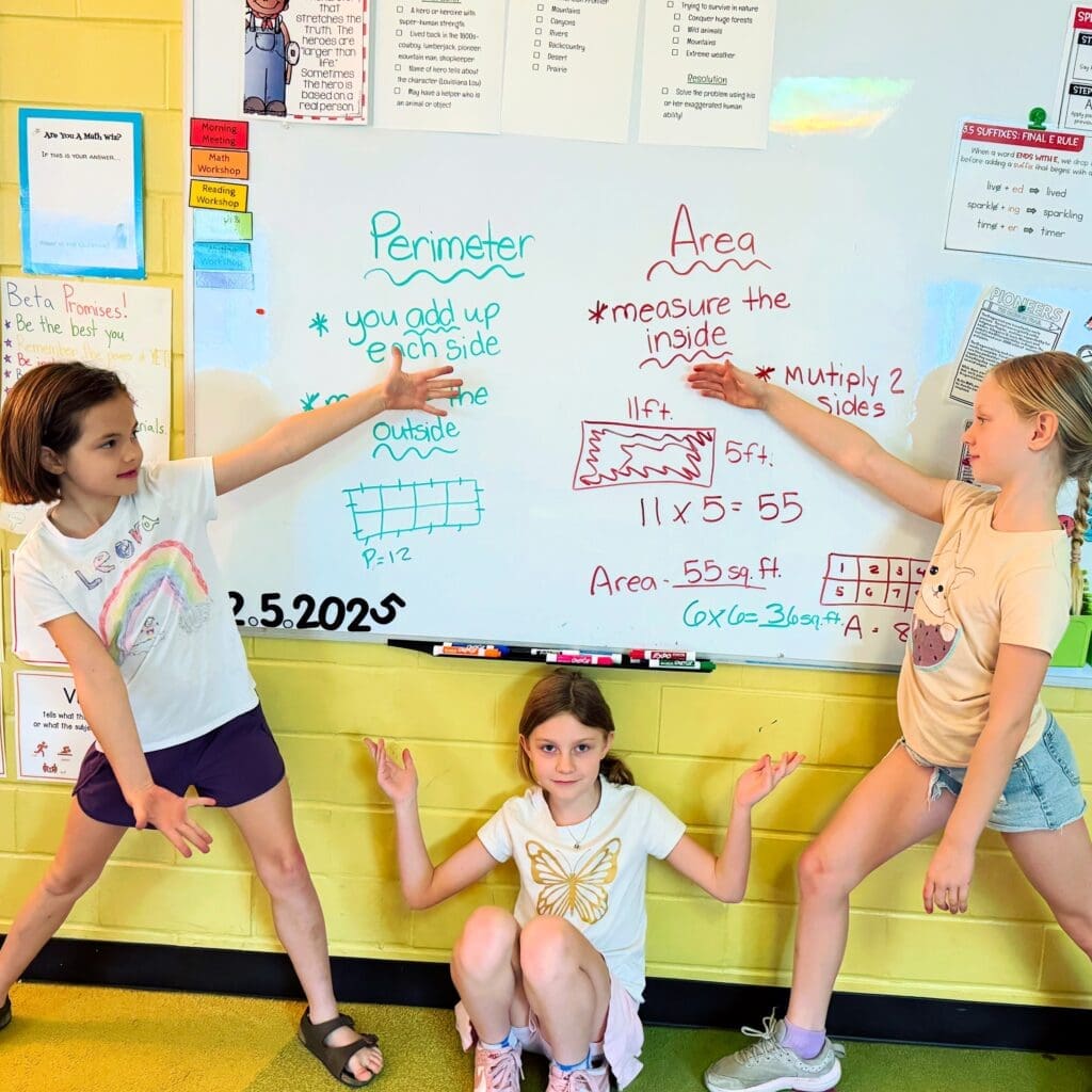 Three elementary students point at board at micro school in Austin.