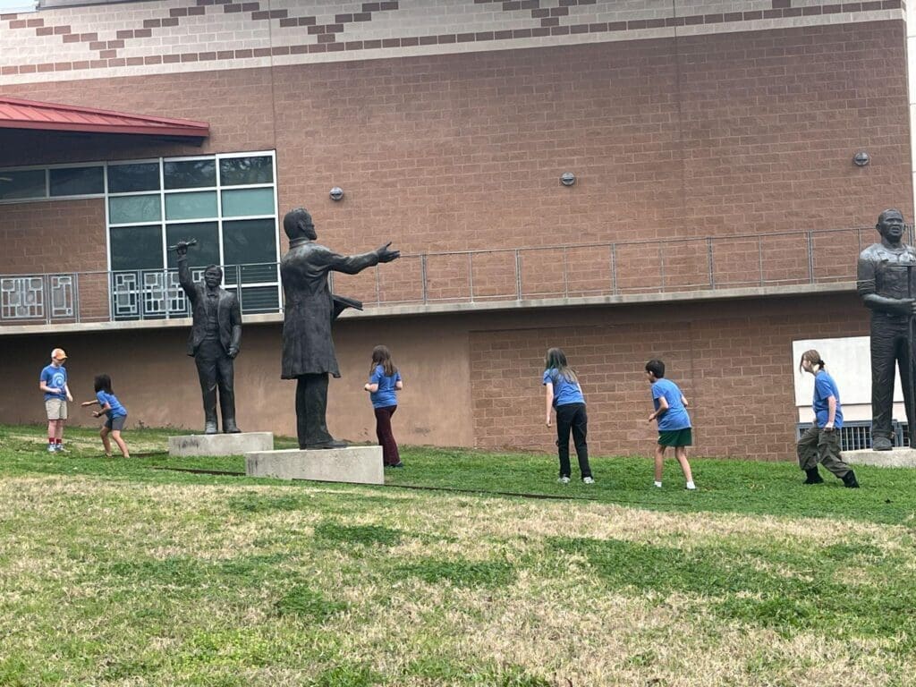 Elementary students walk outside at field trip at private school in Austin.