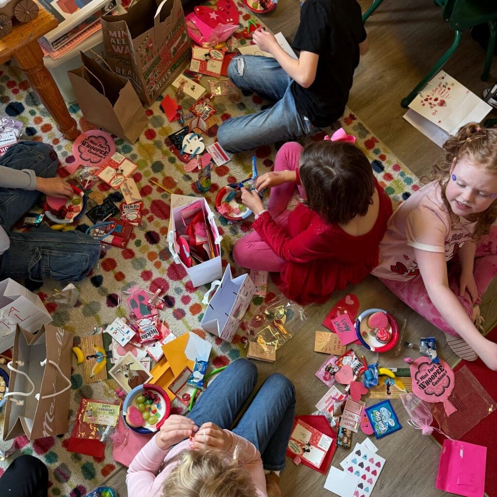 Elementary students craft on the floor at private school in Austin.