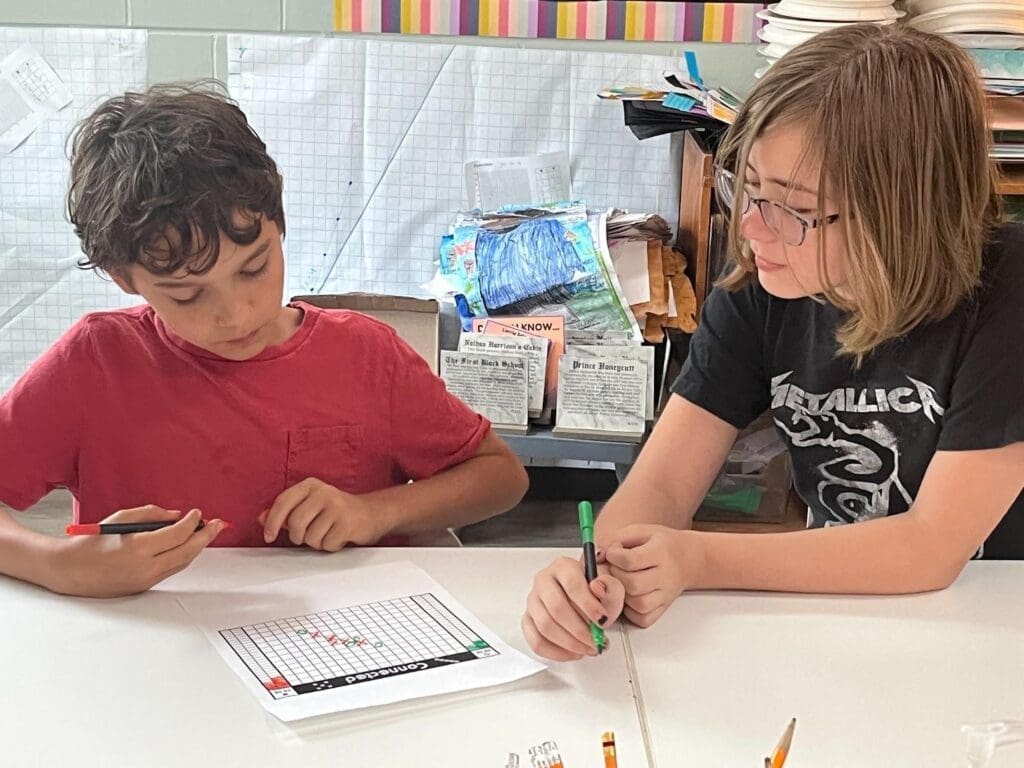 Elementary students work together on math work at STEM school in Austin.