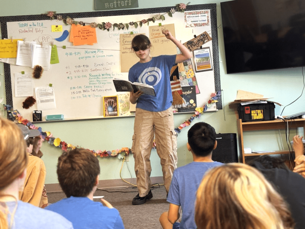 Middle school girl recites poetry before class at project based school.