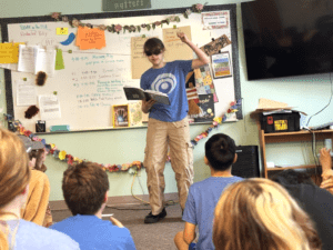 Middle school girl recites poetry before class at project based school.