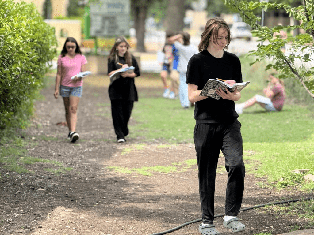 Middle schoolers walk outdoors at micro school in Austin.