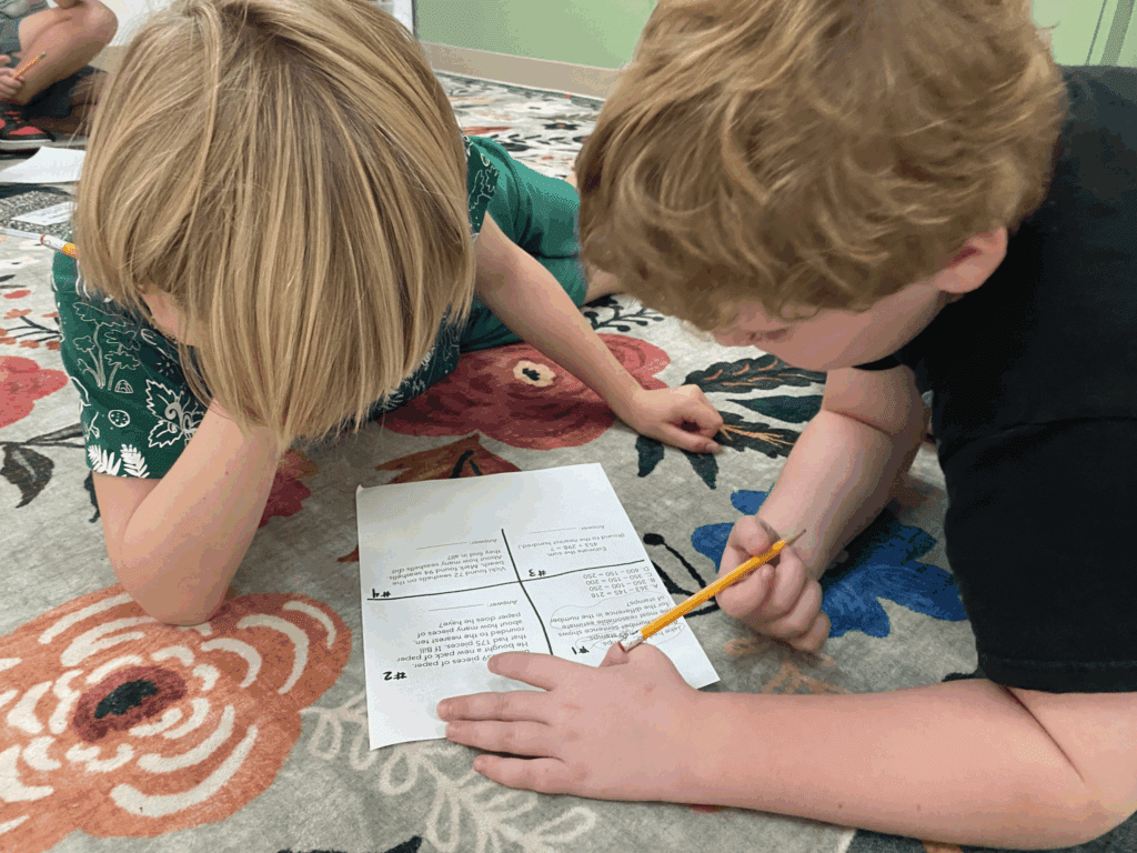 Two third grade boys study math together at STEM school.