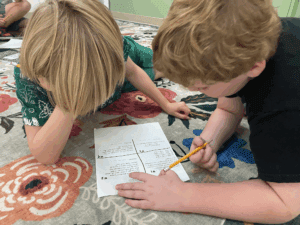 Two third grade boys study math together at STEM school.