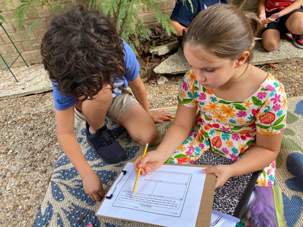 Two elementary students work together at micro school.
