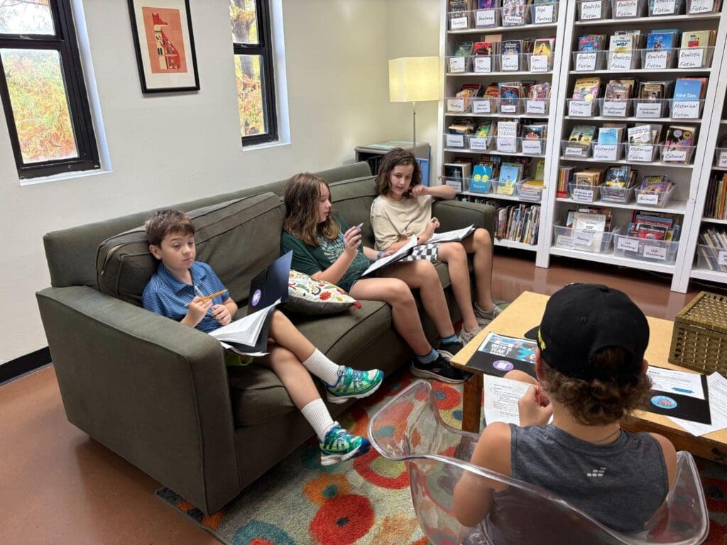 Middle school students learn comfortably on sofa at school with small classes in Austin.