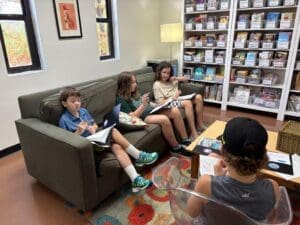 Middle school students learn comfortably on sofa at school with small classes in Austin.