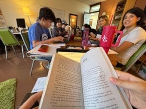Middle school students discuss book at gifted school in Austin.