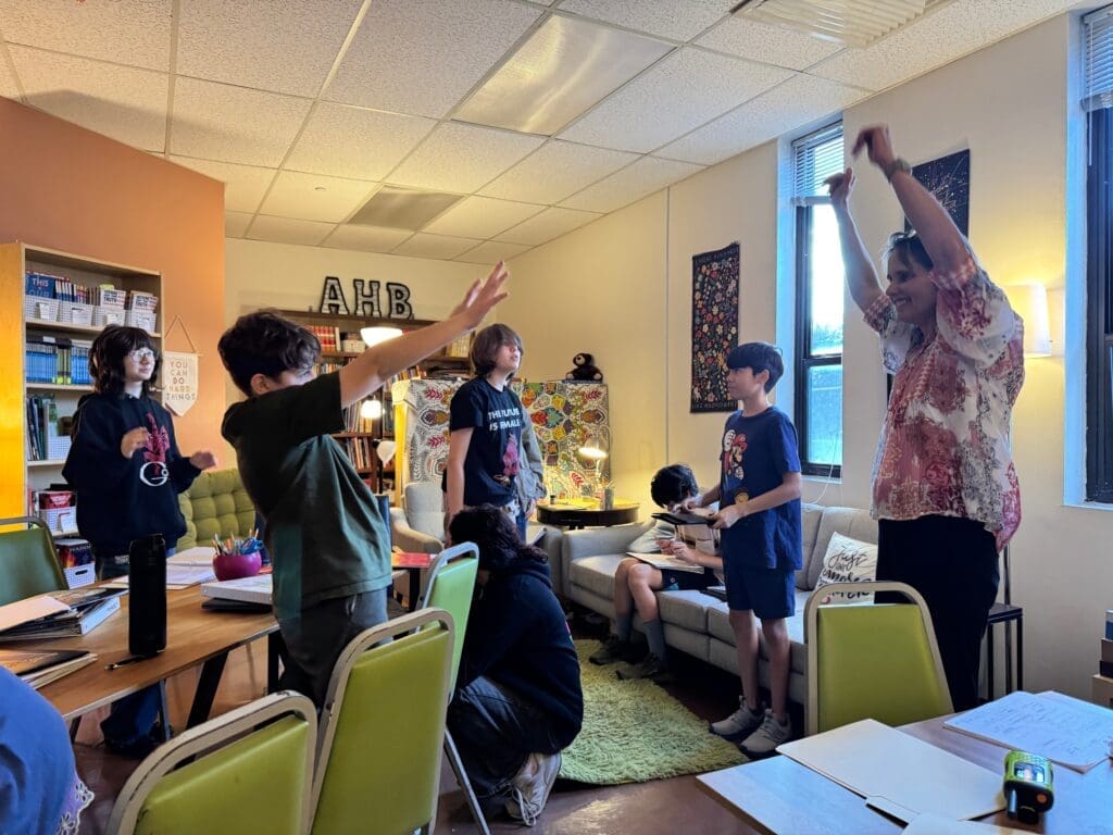 Middle school students celebrate with teacher at part time school in Austin.