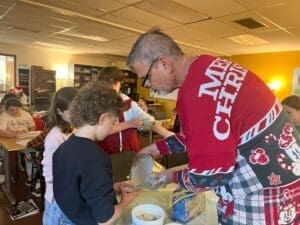 Teacher helps students with project at micro school.
