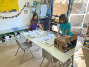 Elementary students look at project at STEM school.