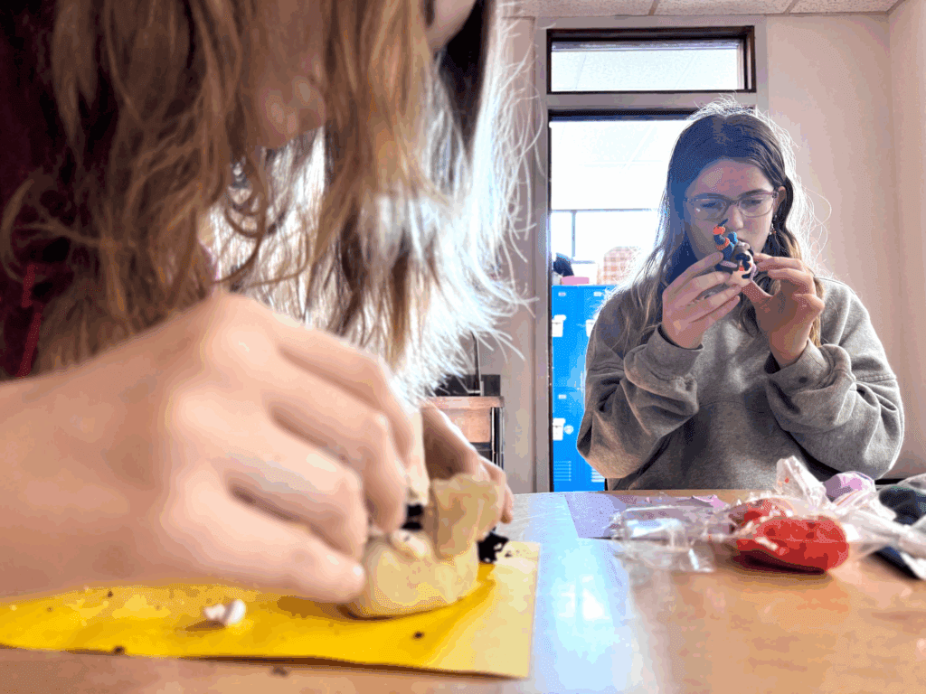 Middle school students work on details at project based school.