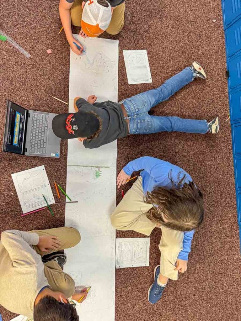 Middle school students work on project together at part time school in Austin.