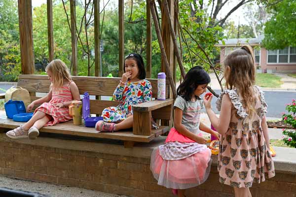 Kindergarten students eat lunch outdoors at private school in Austin.