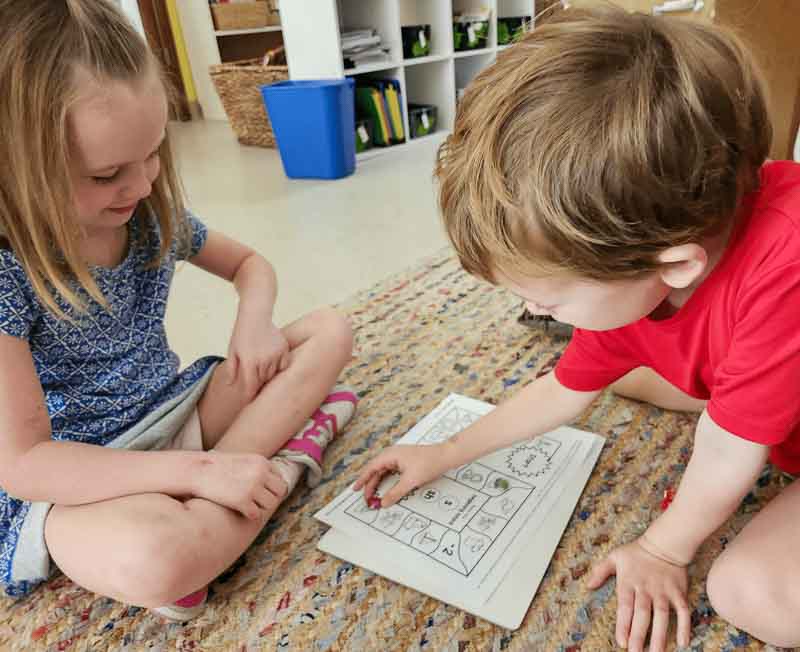 Kindergarten students play math game at school with small classes.