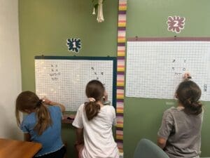 Middle school students graph together at STEM school.
