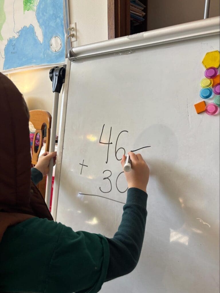 Kindergarten student works with addition at STEM school in Austin.