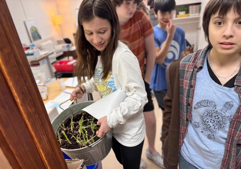 Middle school student works with plants at micro school.