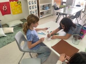 Two elementary students work together at project based school.