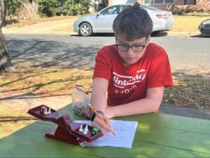 Middle school student completes worksheet at school with small classes.