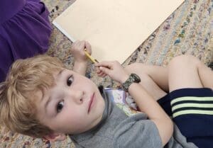 Kindergarten student looks up from work at micro school.