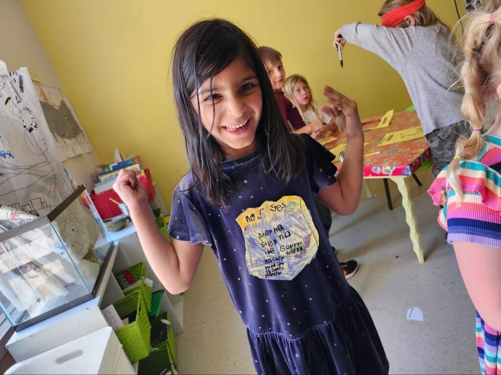 Kindergarten student poses happily at micro school.