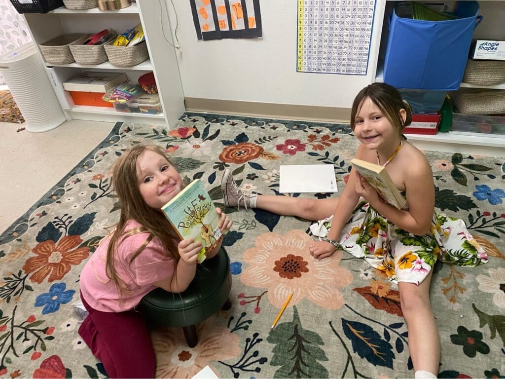 Elementary students read together at school with small classes.