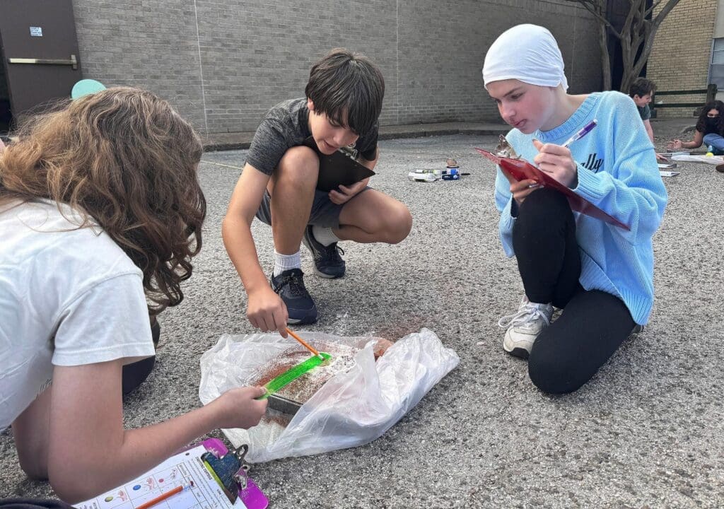 Middle school students work on science project at STEM school in Austin.